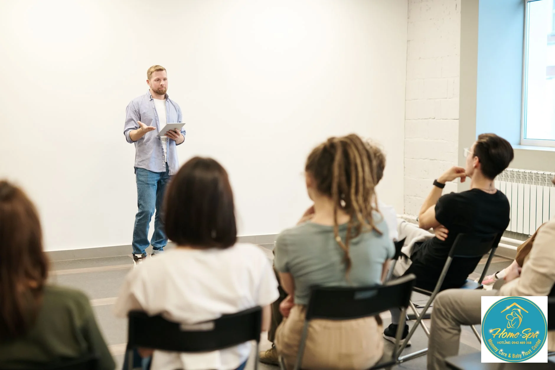 professional photo of a diverse group of adults (teachers, parents, aspiring educators) attending an early childhood education training workshop, actively engaging with a lecturer, warm lighting, 1024x1024