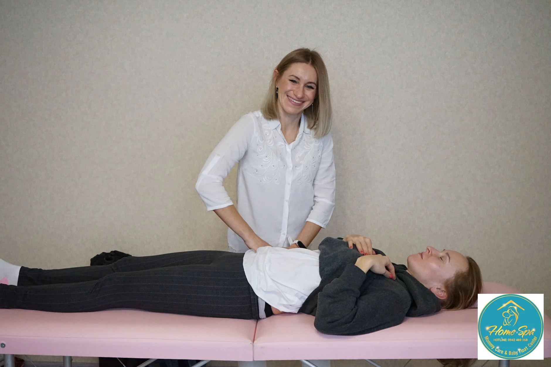 a professional female therapist gently massaging a mother's breast to aid lactation, warm and comforting setting, 1024x1024