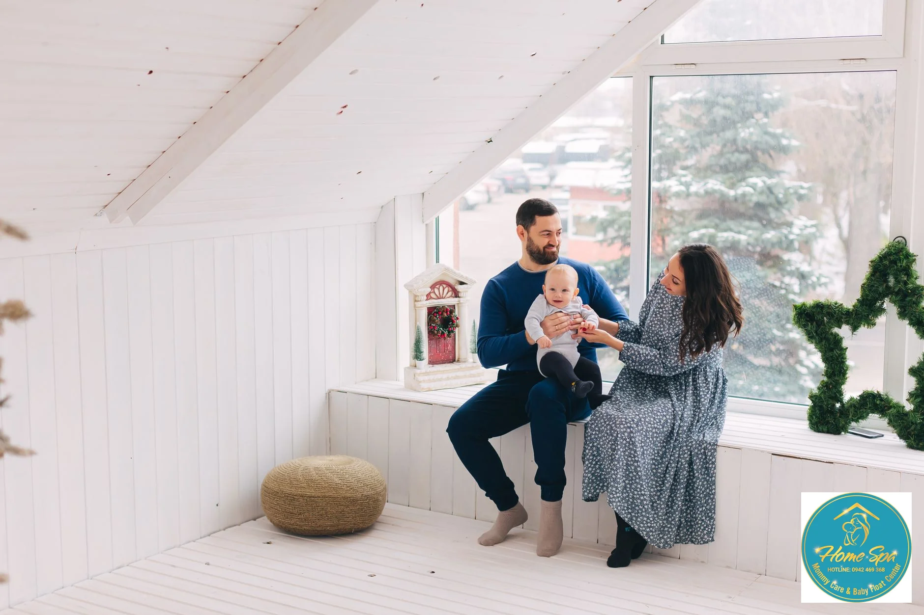 a professional photo of a mother and baby warmly dressed in a cozy room, symbolizing care in cold weather, with a window showing a winter scene outside in Bac Giang, 1024x1024