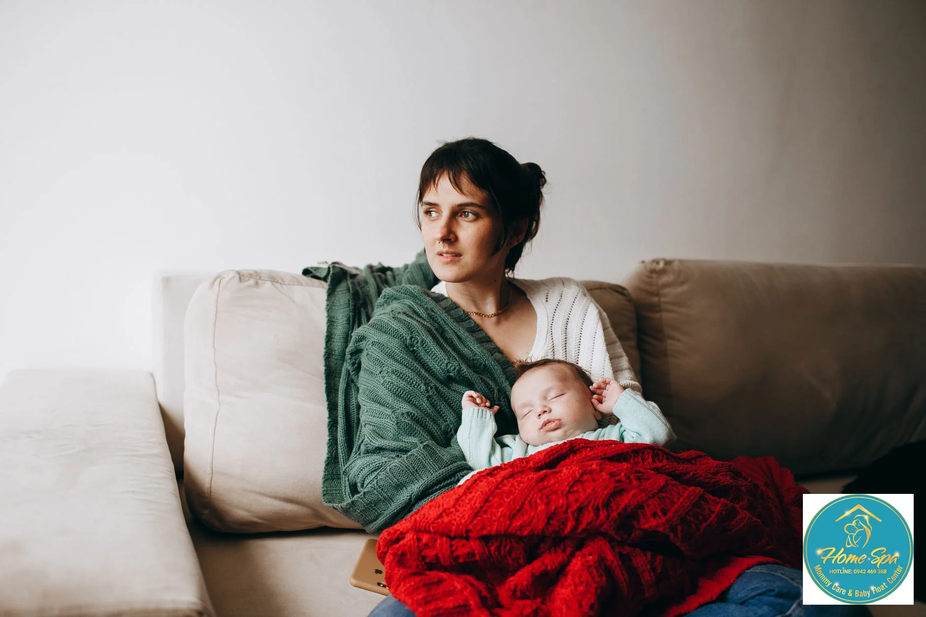 professional photo of a cozy home environment with a mother and baby, emphasizing warmth and comfort, possibly a humidifier or gentle lighting in a room in winter, 1024x1024