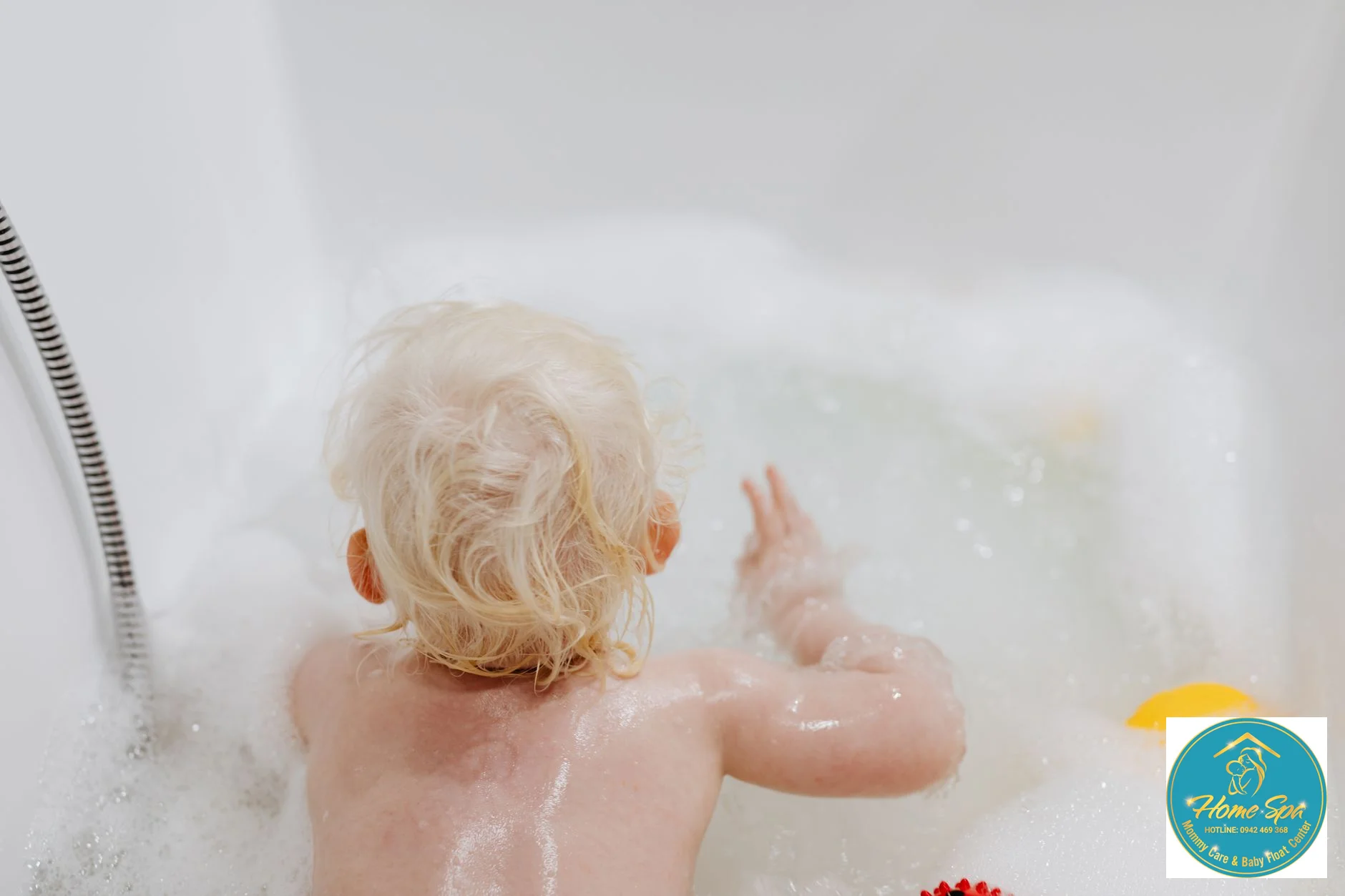 professional photo of a baby in a hydrotherapy pool, gentle bubbles, warm lighting, happy baby, nurse observing, 1024x1024