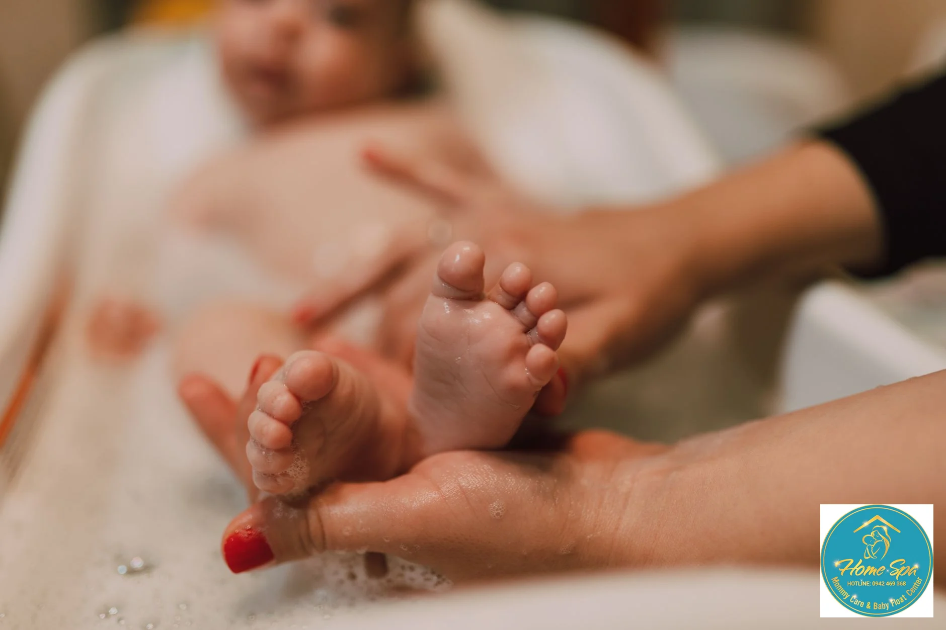 close-up professional photo of a baby receiving gentle massage after bath, soft hands, peaceful expression, 1024x1024
