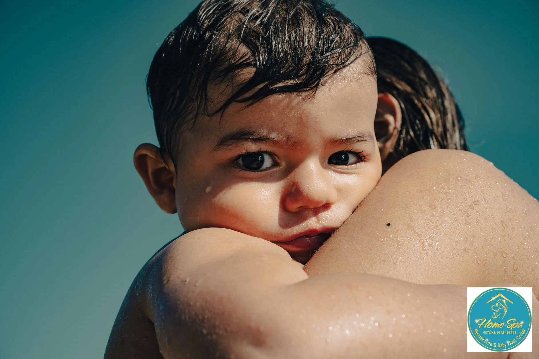 close-up professional photo of a baby's happy face while playing in water, with a gentle and supportive adult hand nearby, 1024x1024