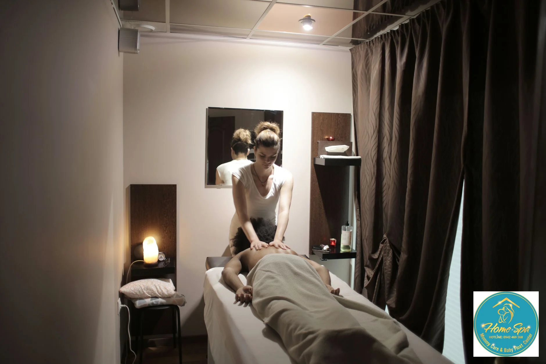 candid photo of a HomeSpa therapist gently massaging a baby's tummy after a hydrotherapy session, warm and caring atmosphere, 1024x1024