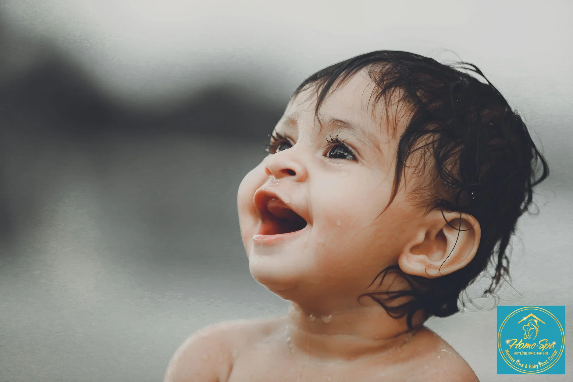 close-up shot of a baby's joyful face during a professional bath, gentle splashing, clear water, focus on happiness, 1024x1024