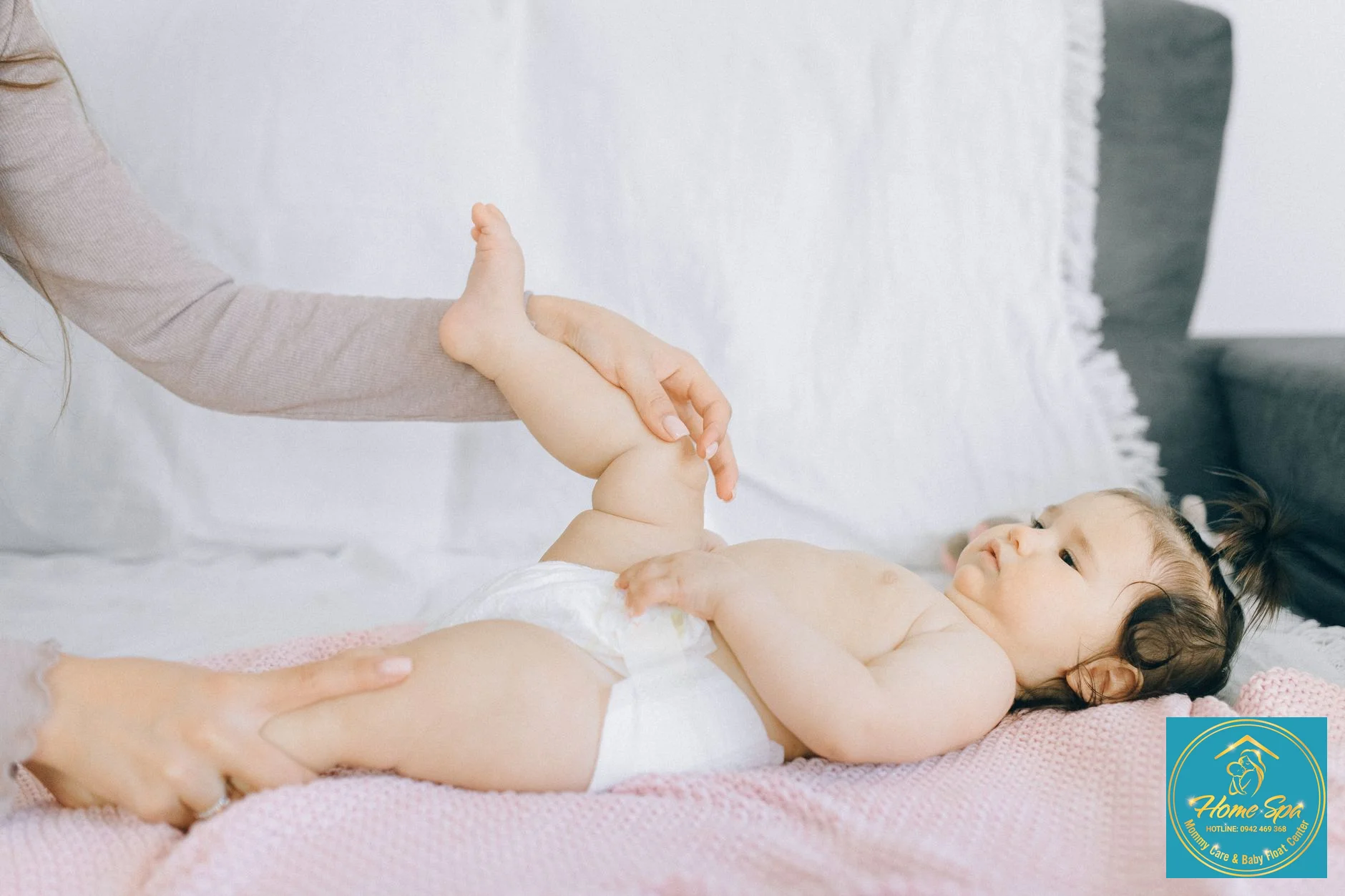 professional photo of a mother gently massaging her newborn baby during bath time, soft lighting, focus on hands and baby's peaceful face, 1024x1024