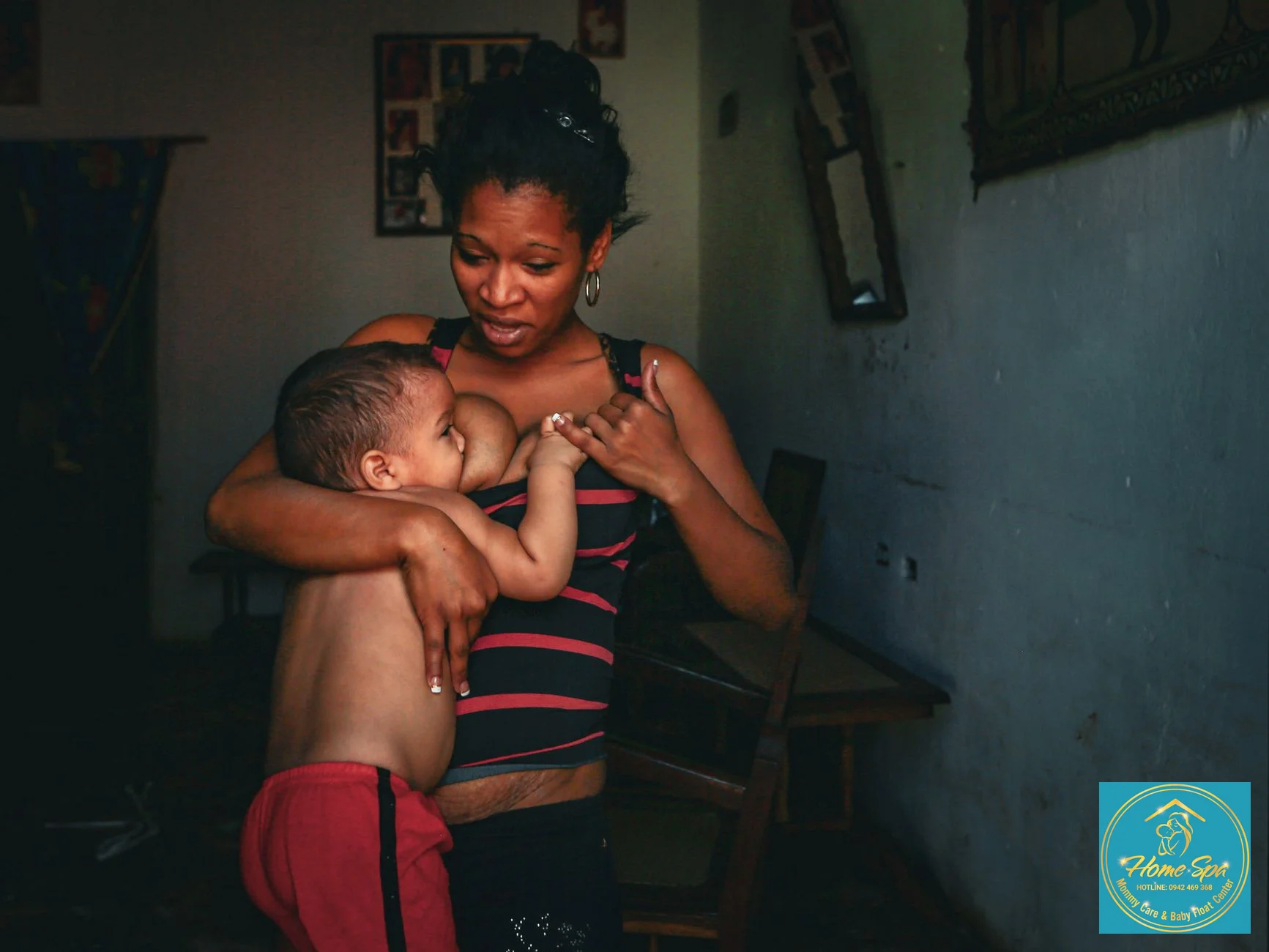 professional photo of a lactation nurse demonstrating proper breastfeeding position to a new mother, cozy home environment, 1024x1024